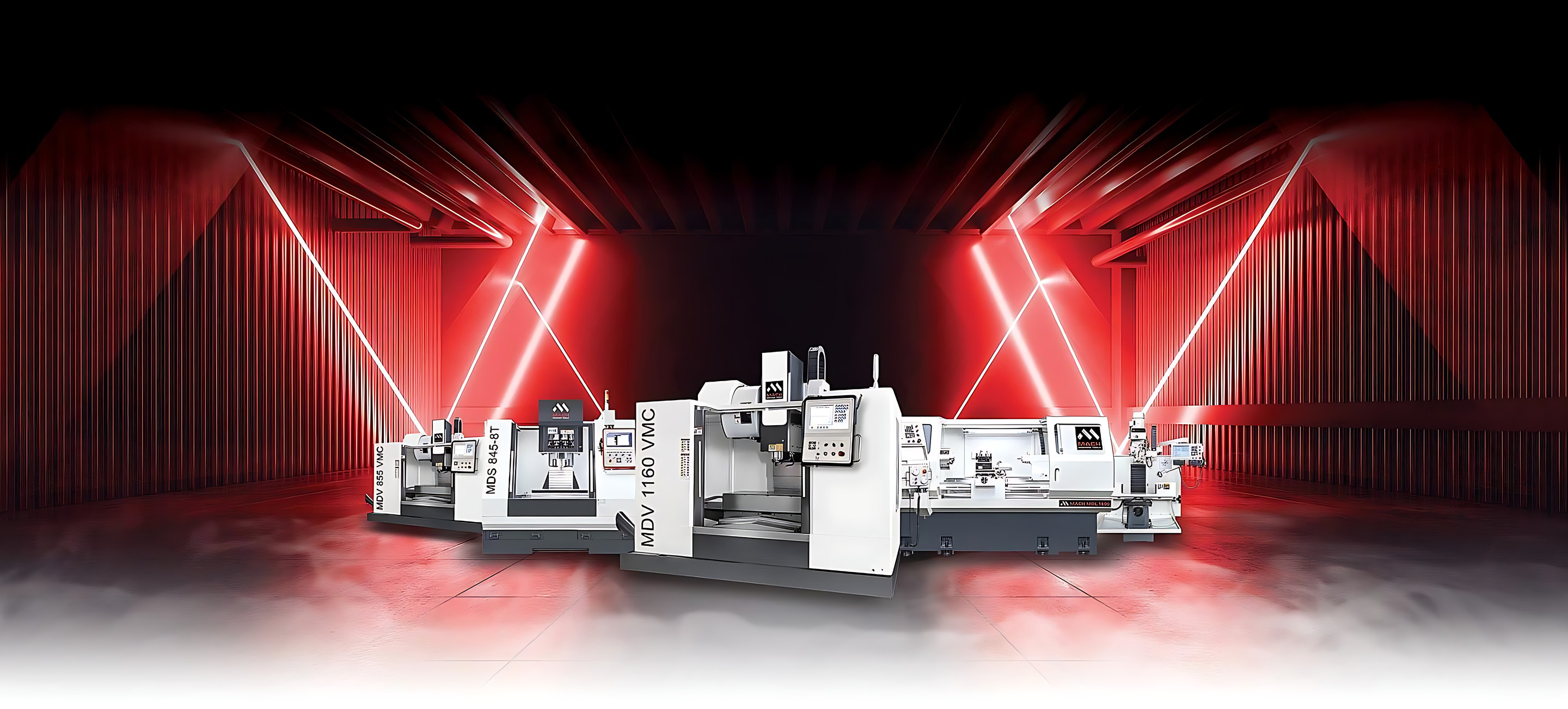 A line-up of MACH CNC machining centres and a lathe, including the MDV 1160 VMC, lit in red